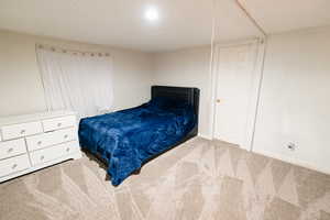 Bedroom featuring carpet flooring and baseboards