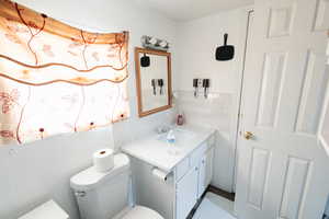Bathroom featuring vanity and wood walls