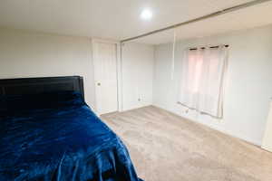 Unfurnished bedroom with baseboards and carpet flooring