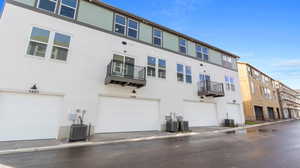Rear view of house featuring a balcony and stucco siding