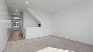 Empty room featuring light colored carpet and recessed lighting