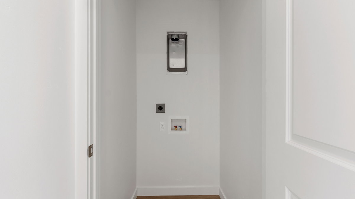 Laundry room featuring wood finished floors, hookup for an electric dryer, and washer hookup