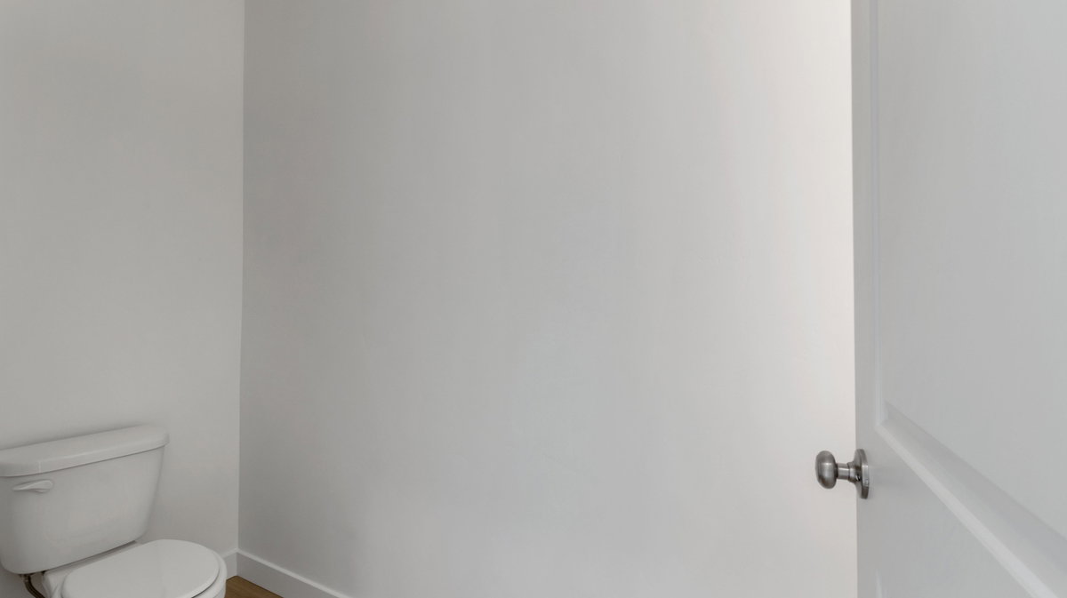 Bathroom with toilet and baseboards