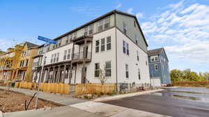 View of building exterior featuring a residential view and a garage