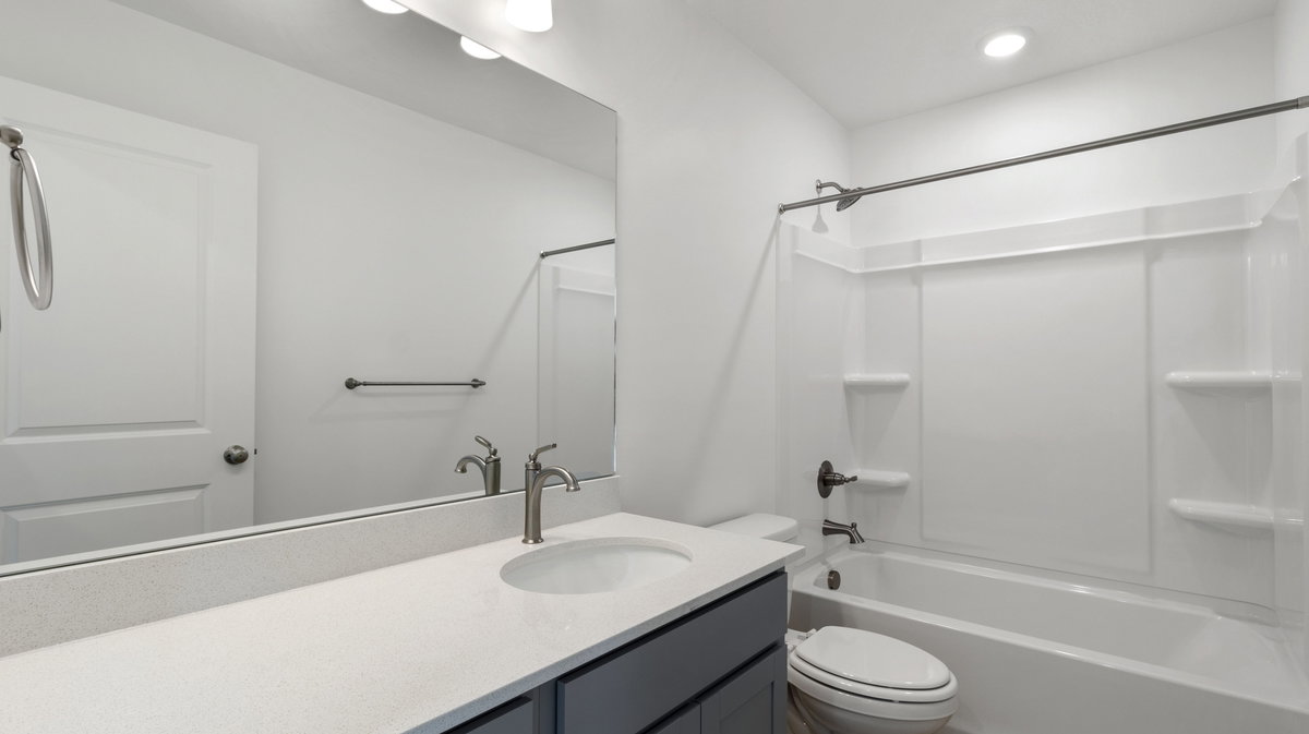 Bathroom with vanity, shower / tub combination, and recessed lighting
