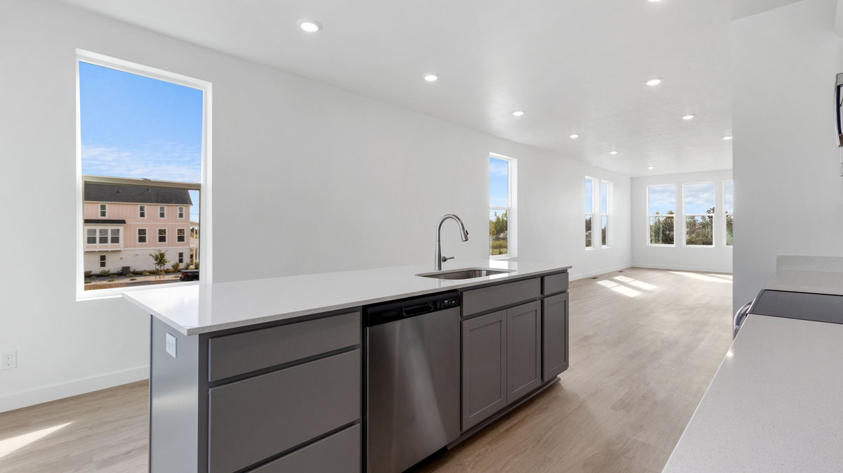 Kitchen with gray cabinets, recessed lighting, a center island with sink, light wood-style floors, and dishwasher