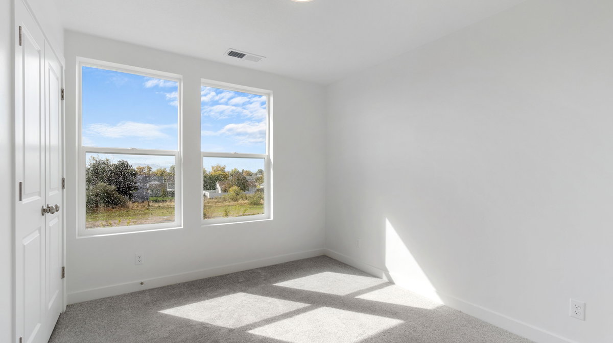 Carpeted spare room with baseboards