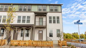 View of front of house with stucco siding, a balcony, and a fenced front yard