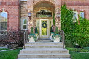Doorway to property with brick siding and stone siding