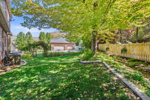 Fenced backyard featuring a mountain view and a garage