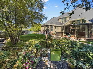 Rear view of house featuring a fenced backyard, a shingled roof, and brick siding