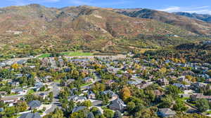 Aerial overview of property's location with mountains and nearby suburban area