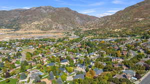 Aerial overview of property's location featuring a mountain backdrop and nearby suburban area