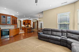 Living room featuring recessed lighting, arched walkways, a ceiling fan, light wood-style floors, and wine cooler