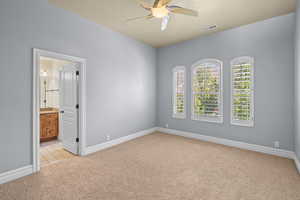 Unfurnished room featuring light carpet and a ceiling fan