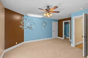 Unfurnished bedroom featuring carpet flooring and a ceiling fan