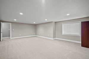 Spare room featuring light carpet and recessed lighting