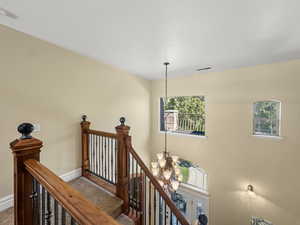 Stairs featuring a chandelier