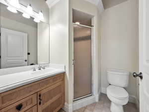 Bathroom with vanity, light tile patterned flooring, and a stall shower