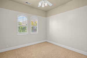 Empty room with carpet and ceiling fan
