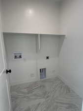 Washroom featuring hookup for a washing machine, light marble finish flooring, and hookup for an electric dryer