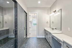 Bathroom with vanity, recessed lighting, dark marble finish floors, and a marble finish shower