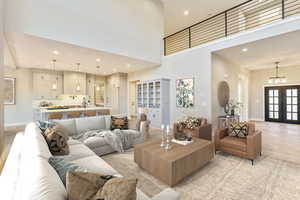 Living room with recessed lighting, a towering ceiling, french doors, and light wood finished floors