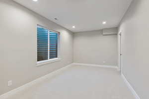 Unfurnished room featuring light carpet and recessed lighting
