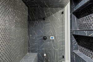 Bathroom featuring a marble finish shower