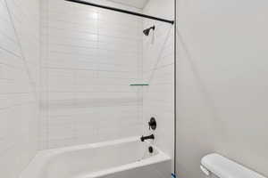 Full bathroom featuring shower / bath combination and toilet