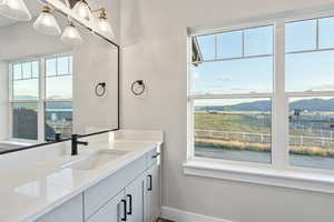 Bathroom with a mountain view, vanity, and healthy amount of natural light