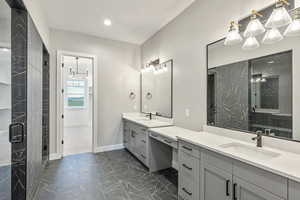Full bathroom with a marble finish shower, two vanities, dark marble finish floors, a chandelier, and recessed lighting