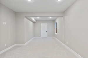 Unfurnished room featuring light carpet and recessed lighting
