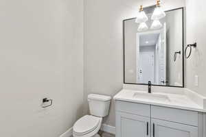 Half bath featuring vanity and toilet