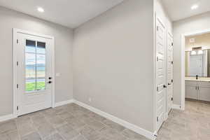 Doorway to outside featuring recessed lighting and baseboards