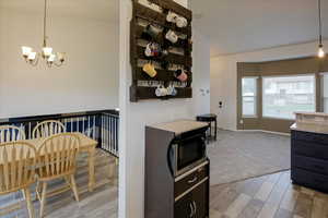 Dining room with a chandelier and light carpet