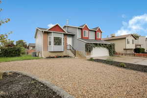 Split level home with driveway and an attached garage