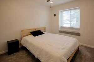 Bedroom featuring dark colored carpet, ceiling fan, and recessed lighting