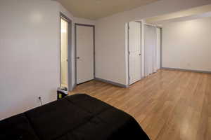 Bedroom featuring light wood finished floors and baseboards