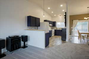 Kitchen with decorative backsplash, light countertops, white appliances, recessed lighting, and light tile patterned floors