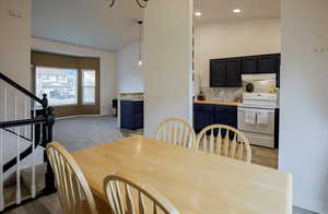 Dining room featuring light carpet, stairway, and recessed lighting