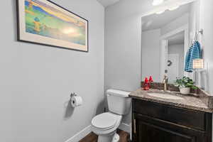 Bathroom featuring vanity and dark wood-style flooring