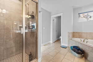 Bathroom with a bath, a shower stall, and light tile patterned floors