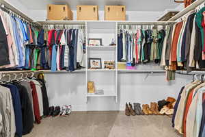 Spacious closet with carpet