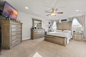 Bedroom featuring light carpet, ceiling fan, and recessed lighting