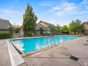 Community pool featuring a patio