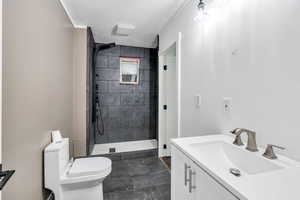 Full bath with a textured ceiling, vanity, and a stall shower
