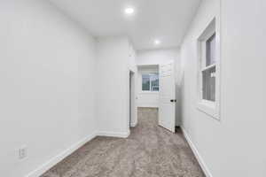 Corridor with carpet floors and recessed lighting