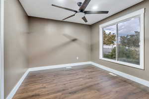 Empty room with wood finished floors, ceiling fan, and recessed lighting