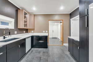 Kitchen with dishwasher, recessed lighting, modern cabinets, light stone counters, and dark cabinets